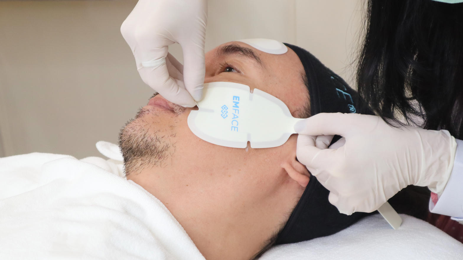 EMFACE cheek applicator on a man