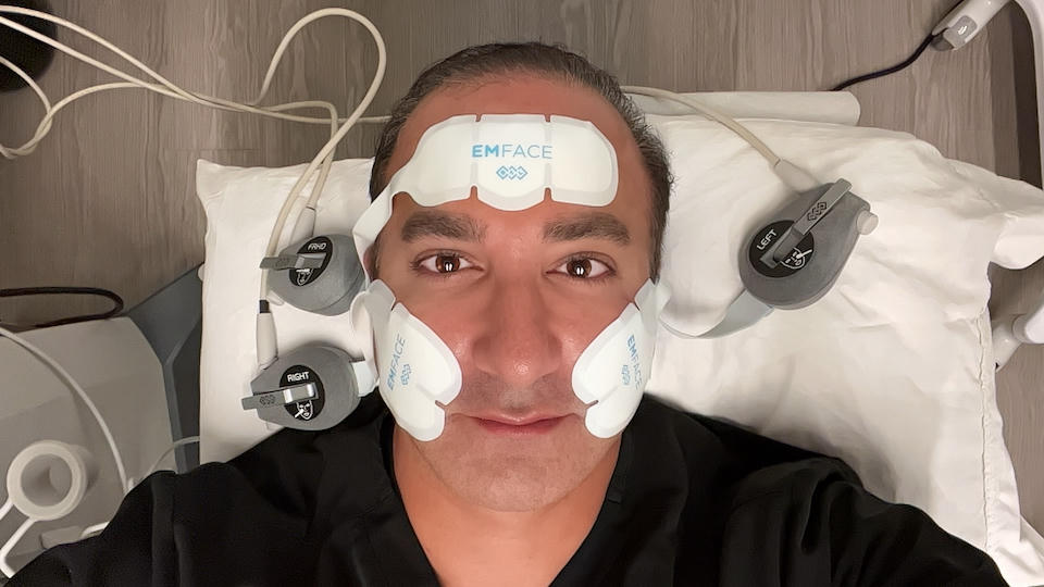Man having EMFACE forehead and cheek applicators